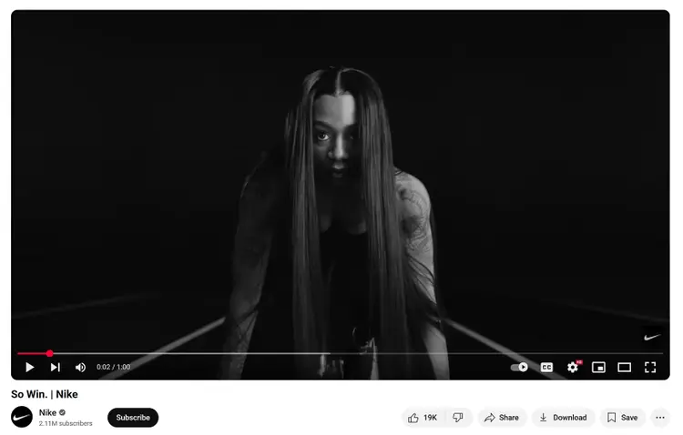 Screenshot from Nike's "So Win" video showing a female athlete in starting position on a track, in black and white.