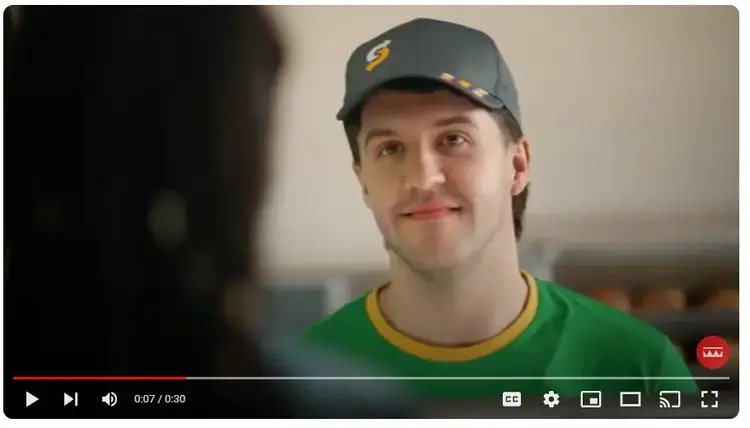 Video player screenshot of man in green shirt and cap